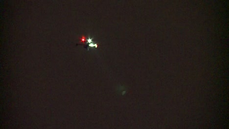 police drone at night searching with spotlight