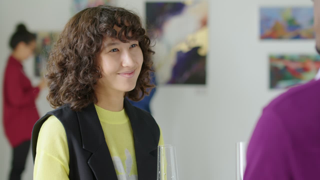 Woman Having Champagne and Talking with Friend in Gallery