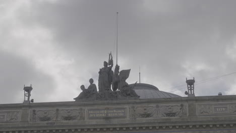 statues on the roof of the royal danish theatre in copenhagen denmark log