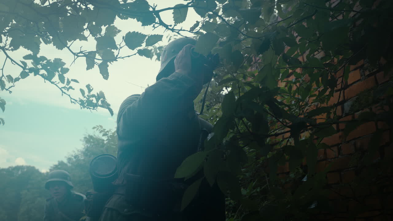 German Soldier Observing Through Binoculars During WWII