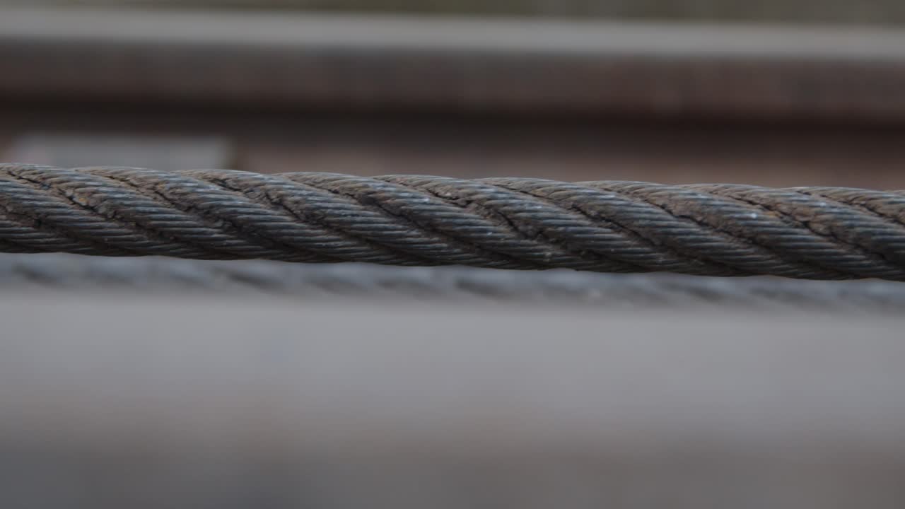 primer plano de mano del cable de hierro trenzado industrial que se retrae