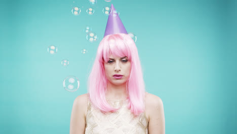 crazy face pink hair woman dancing in bubble shower slow motion photo booth blue background