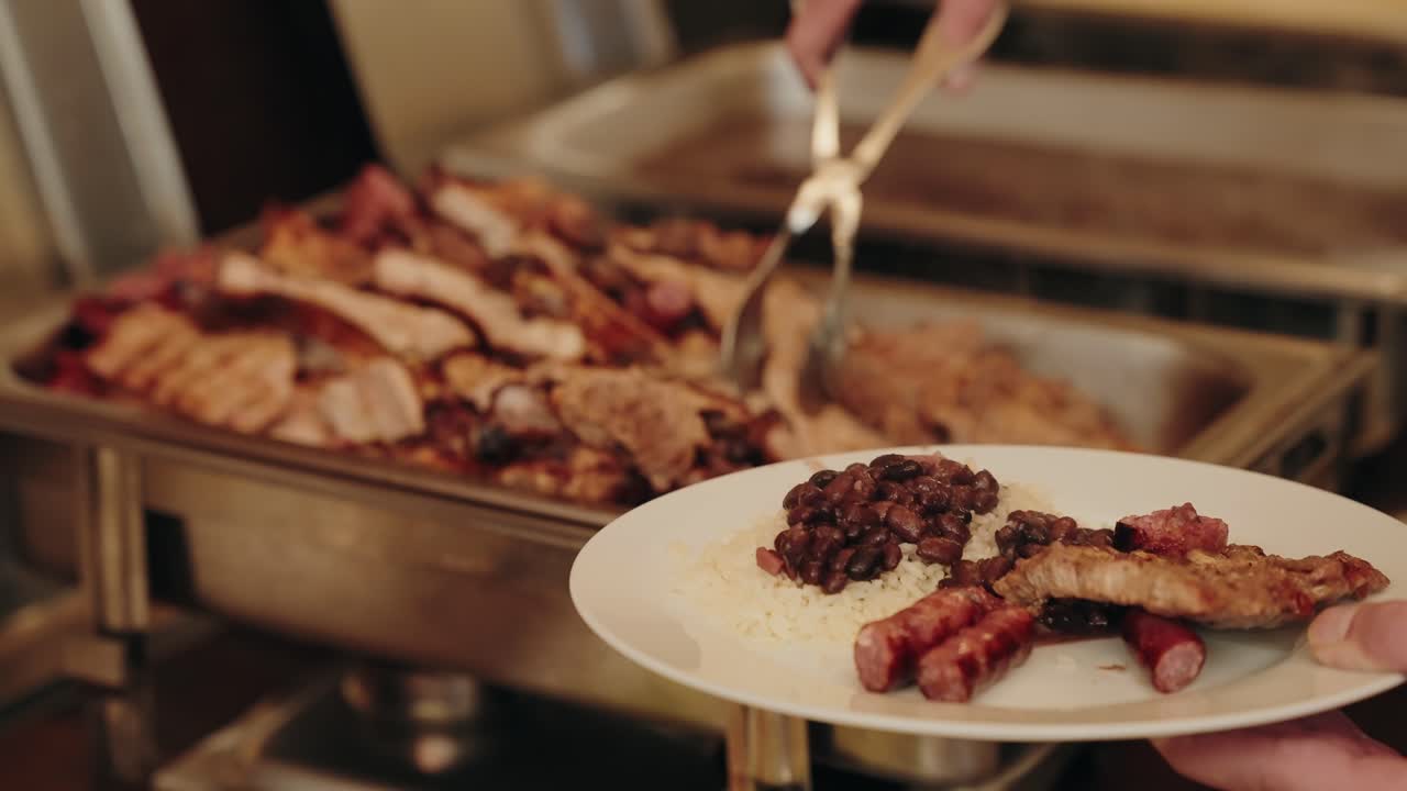 traditional feijoada with rice and sausage served fresh at hot buffet counter