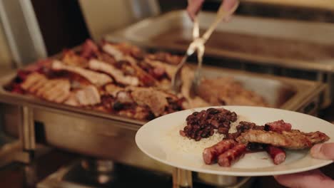 traditional feijoada with rice and sausage served fresh at hot buffet counter
