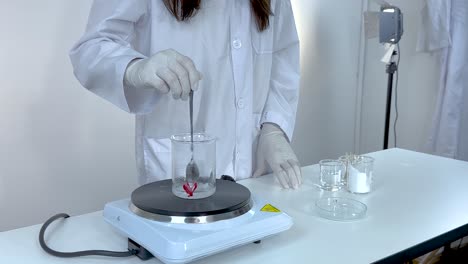 scientist demonstrates sodium acetate crystallization process