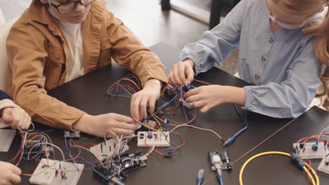 children learning electronics and robotics in a stem workshop