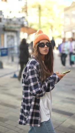 young woman using phone in city