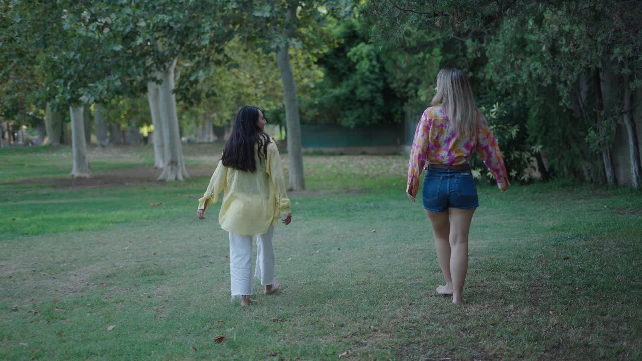 Two Women Friends Walking in a Park