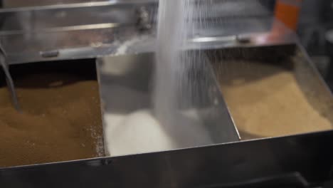 Falling-sugar-filling-stainless-container-coffee-shop-cafe-barista-slow-motion-shallow-depth-of-field