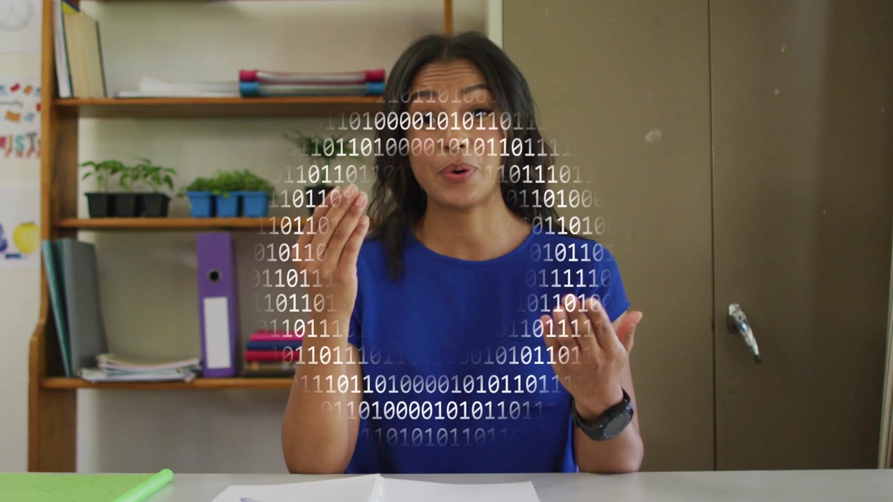 Presenter at desk, speaking and causing binary code to circle head, illustrating tech concepts