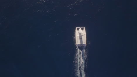 aerial top view of sailing white yacht in empty ocean blue water mauritius island