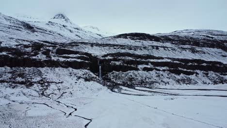 Snowy-mountain-with-waterfall-in-winter