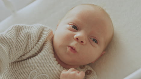 a newborn baby lying in a crib