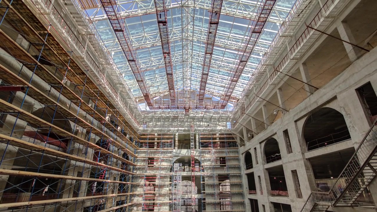 Panorama showing construction equipment material with scaffolding and tools inside the floor of high rising building timelapse, skyscraper. Building under construction. Interior work in progress
