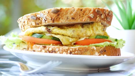 egg sandwich and chips on plate close up