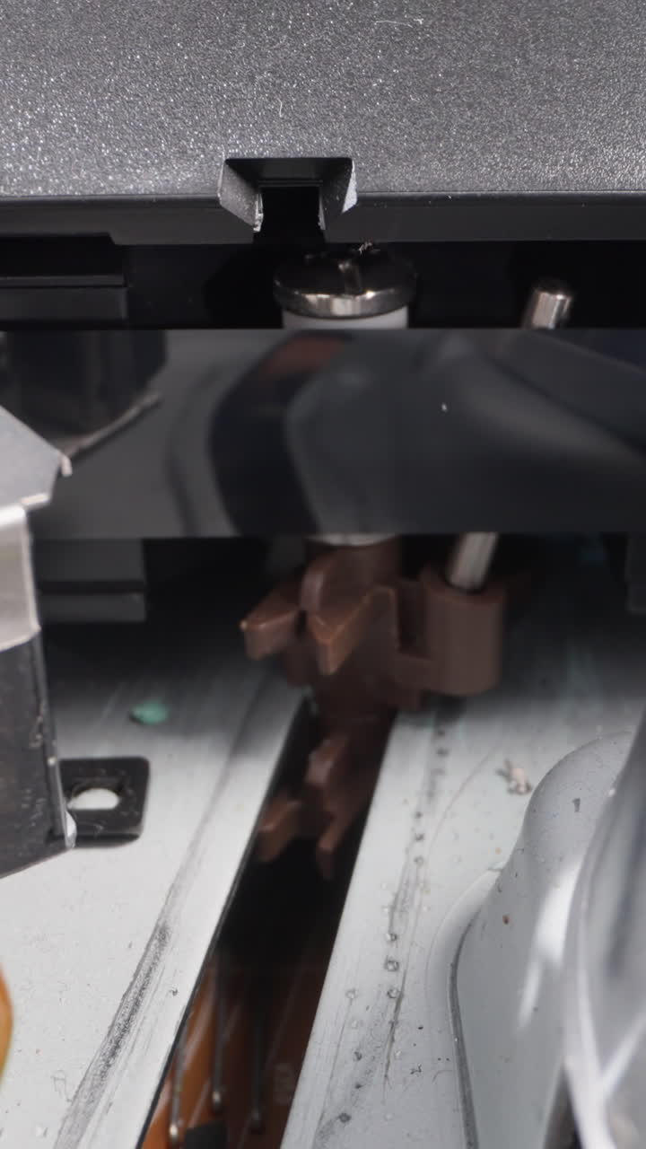 Magnetic tape cassette and vintage tools functioning in studio extreme close view. Vintage technology for movie playing. Old appliance mechanism checkup