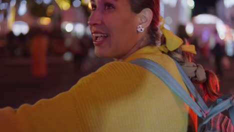 a woman walking in the center of atlixco puebla in the illuminated village