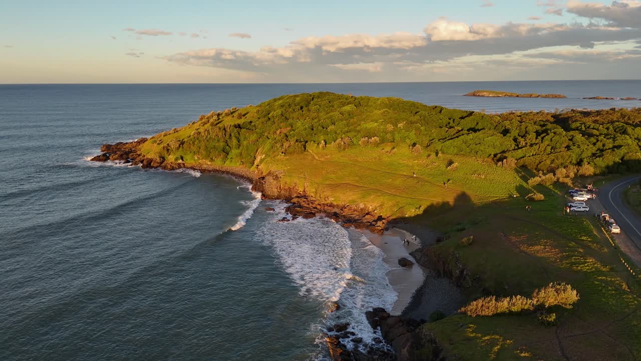 Aerial over peninsula at Racecourse Head with clear water, rocky outcrops and headland, Sydney NSW Australia