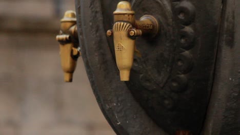 Male-hand-using-water-column-on-city-street.-Drinking-fountain-on-street-city