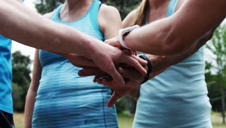 athletics forming hand stack in the park