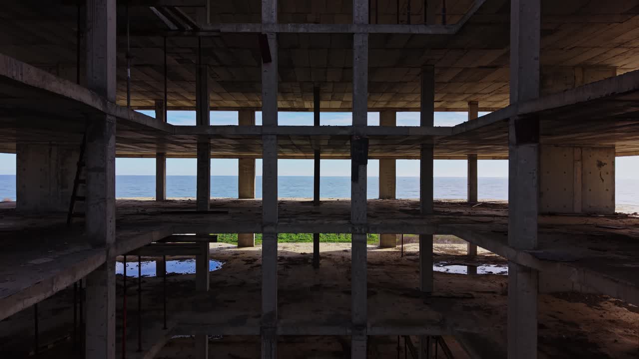 Exploration of an abandoned concrete structure with open sky view