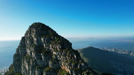 zoom out aerial of lions head mountain peak in cape town south africa at sunset