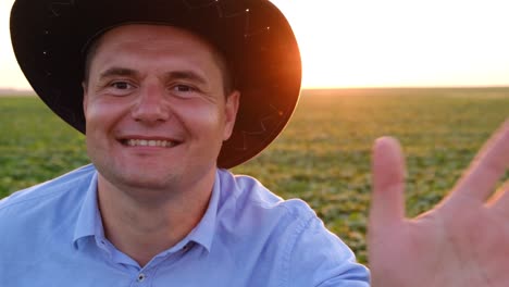 A Happy Farmer is Talking on a Video call Right from his Field at Sunset a Happy Farmer is Talking on a Video call Right from his Field at Sunset the Concept of Agribusiness