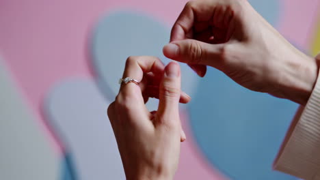 stylish hands adorned with rings and bracelet against abstract background