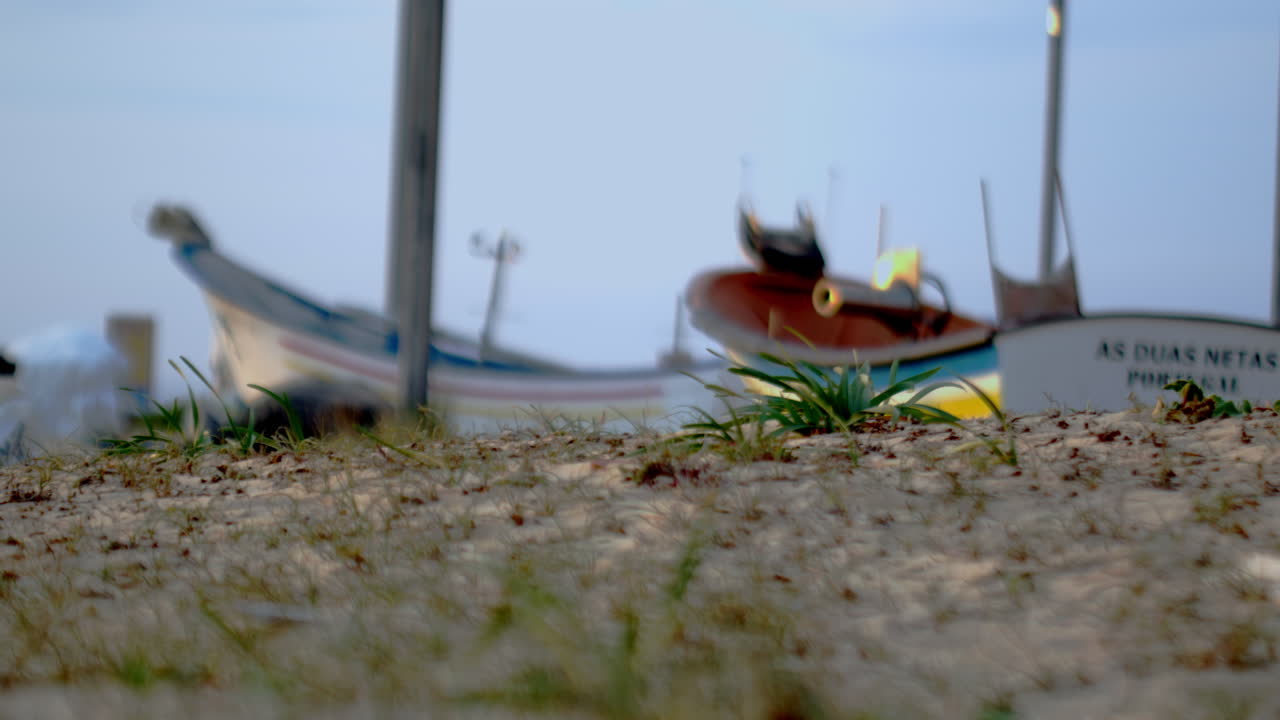 Some fishing boats on land.