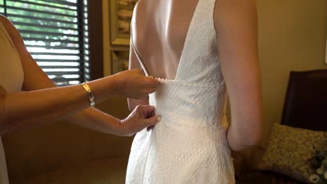 A-bride's-dress-is-zipped-up
