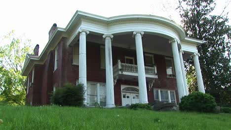 Massive-Stately-Columns-Rise-To-Meet-The-Rounded-Curve-Of-This-Classical-Revival-Style-Home