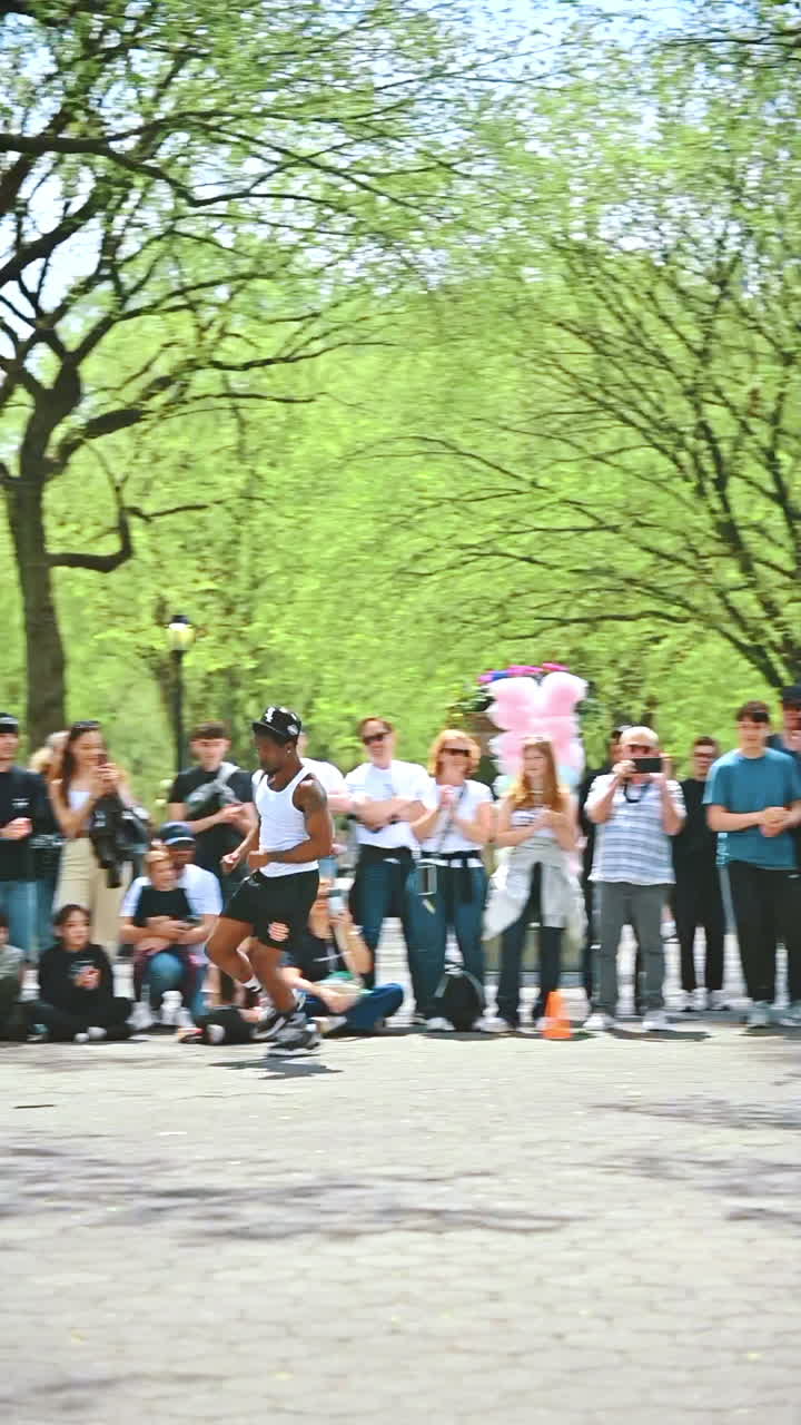 New York, USA, 8 July 2025: New Yorkers outdoors having fun. Groups of people gather in a New York park, engaging in various outdoor activities on a sunny day