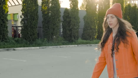 young skater girl skates in a car park