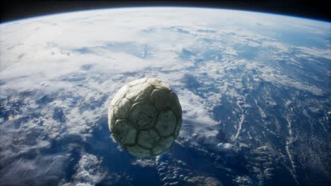 old soccer ball in space on earth orbit