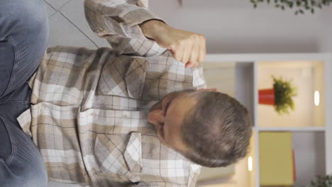 Vertical-video-of-Man-experiencing-joy-looking-at-camera.