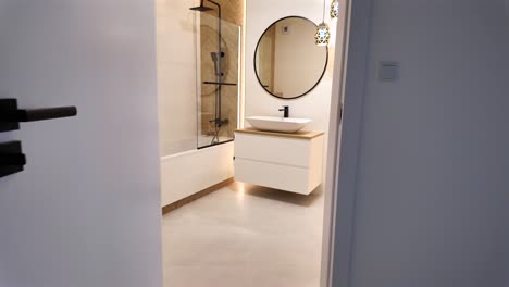 expensive bathroom interior, huge mirror and tub, luxury light