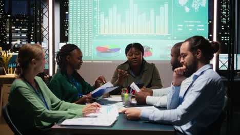 multiethnic group of advisors reviewing data insights and financial situation