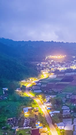 bali, indonesia - driving through a peaceful village in the hills at dusk, with lights glowing along the winding road - timelapse