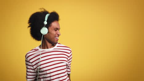 african man listening to music and dances in studio shot