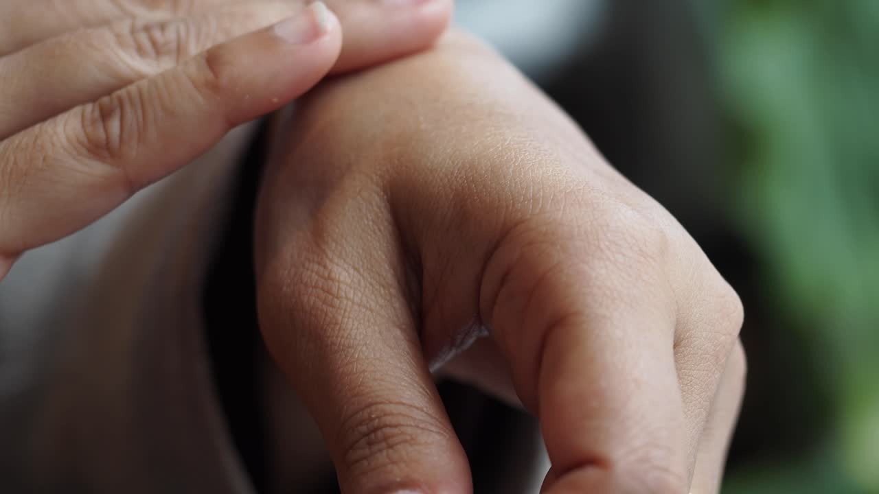 Close-up view of hands adorned with a ring