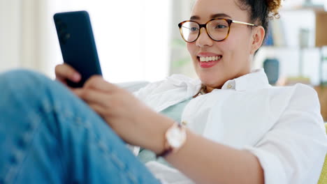 Happy-woman-relax-on-sofa-and-phone-for-internet