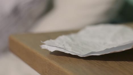 close up of paper pickup from table top