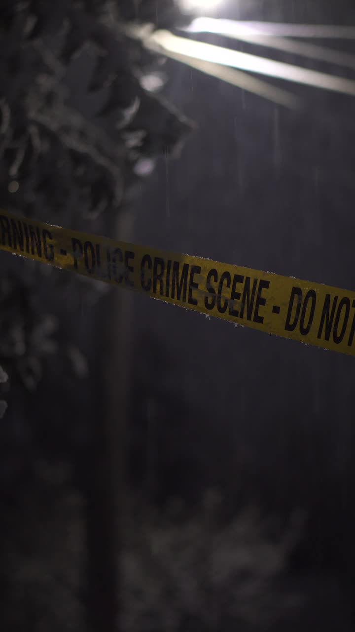 Vertical View, Police Crime Scene Tape RIbbon on Snowy WInter Night