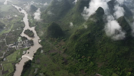 Yulong-River-through-beautiful-Chinese-karst-mountain-landscape,-aerial-reveal