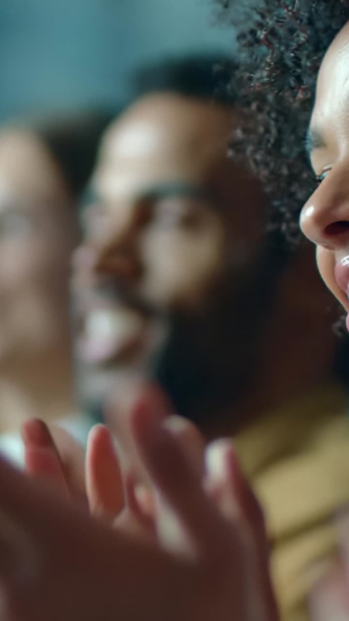 A joyful audience enthusiastically applauding during an engaging performance, capturing the essence of appreciation and shared happiness in the moment