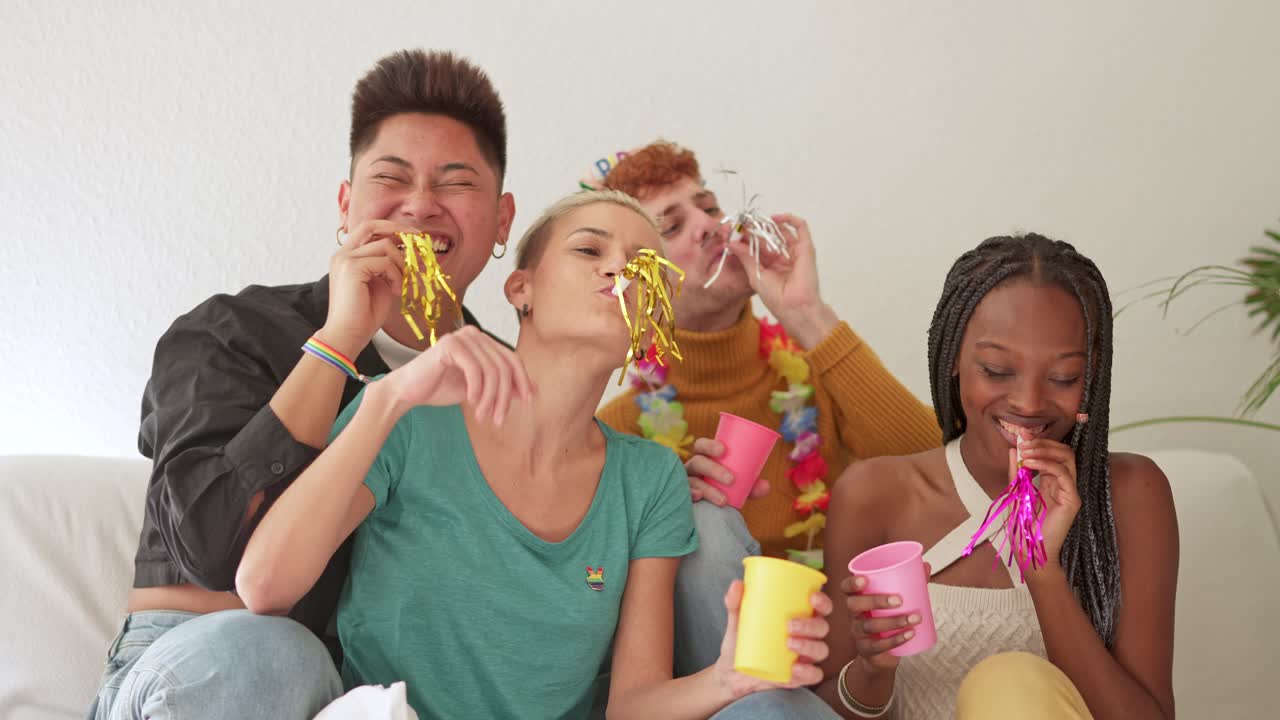 Diverse group of friends celebrating with party blowers