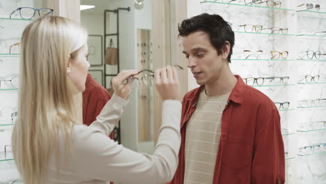 customer trying on glasses in an optical shop