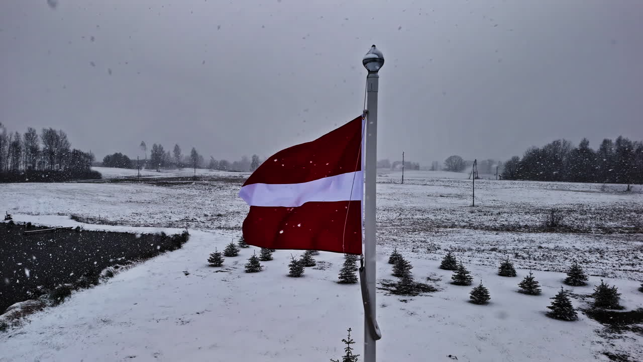 Latvian flag in snowy Cesis, marking independence celebration mood