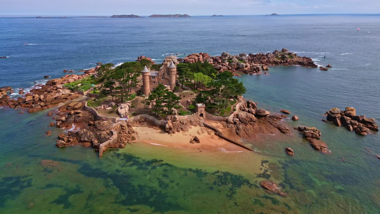 Descending drone movement to the historical and beautiful Costaérès Castle, Trégastel, Côtes-d'Armor, Brittany, France.