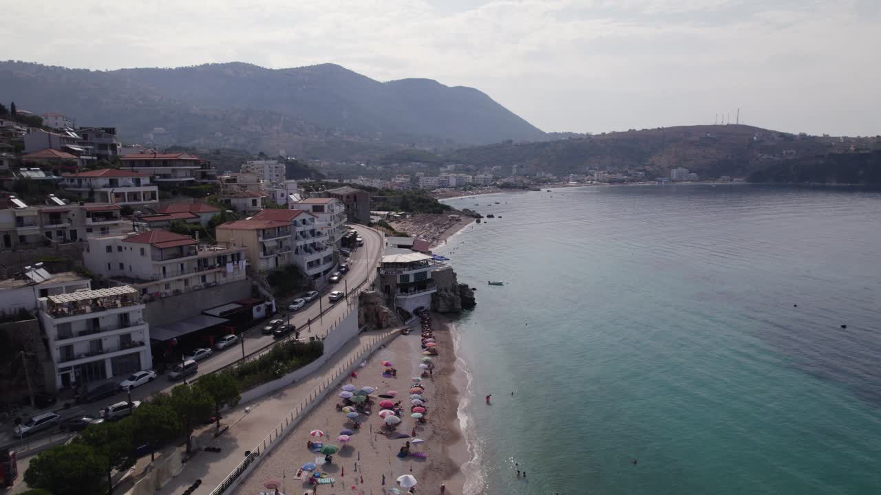 Drone flyover along Himare Coastline, Scenic view of beach shoreline, Albania